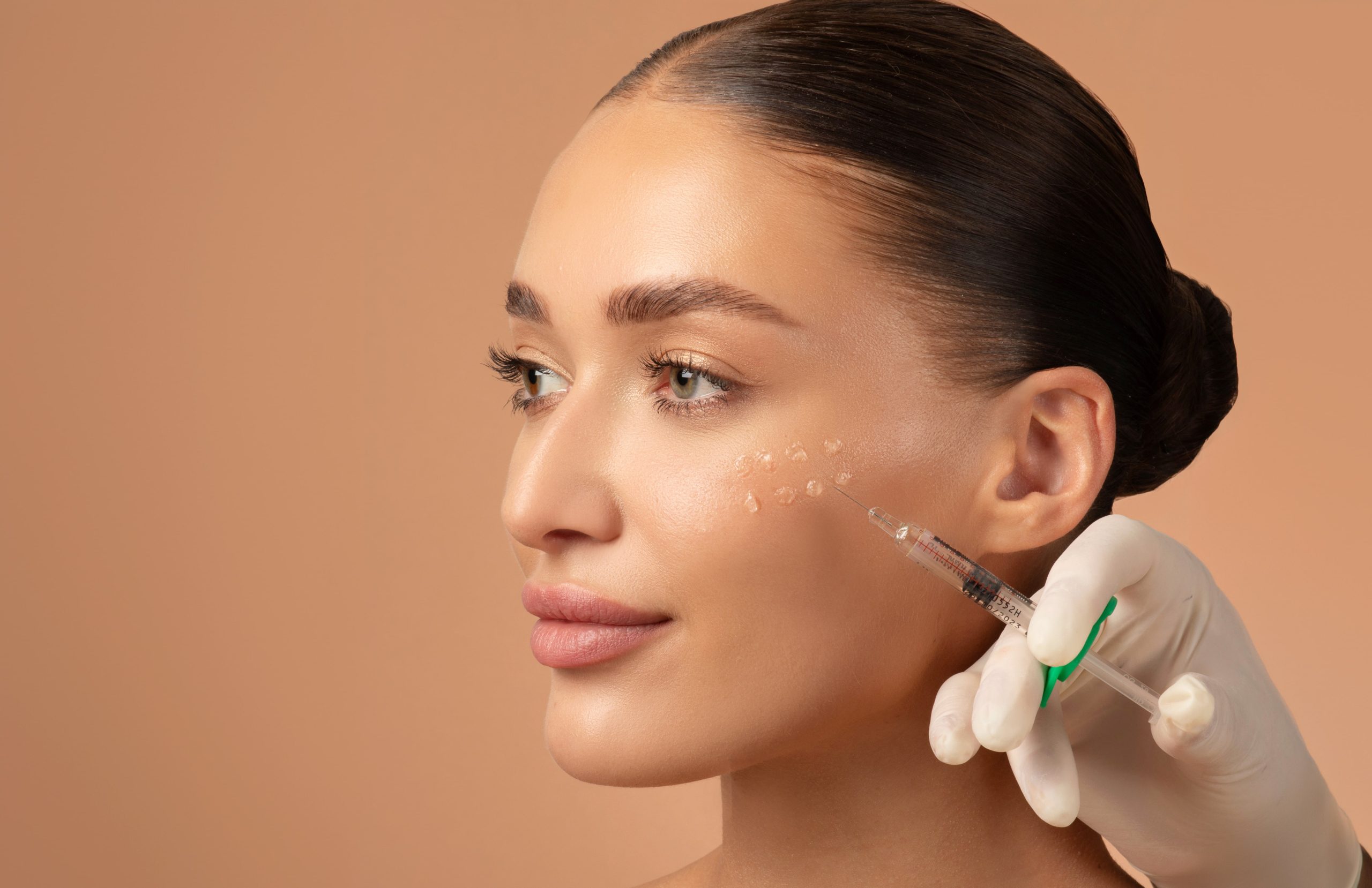 Cosmetologist making rejuvenating anti wrinkle injections on young woman face. Female aesthetic cosmetology in a beauty salon